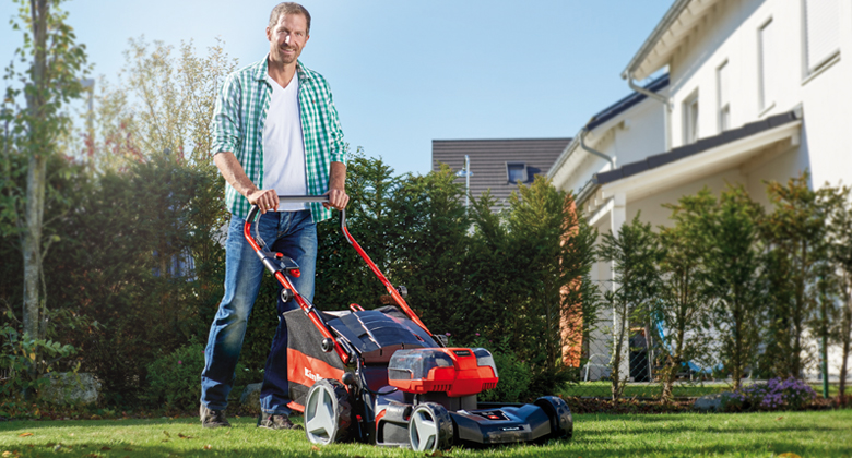 man working with cordless lawnmower